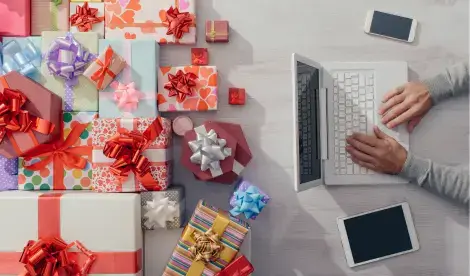 Person sitting at their laptop, working on submitting their payroll early ahead of Christmas.